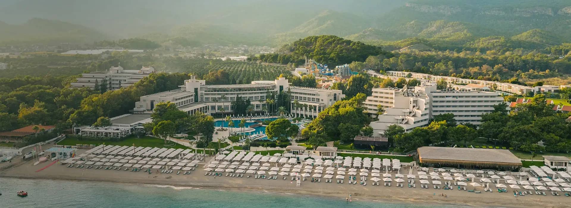 <div style="padding-left: 70px;"><img style="width: 100px; height: auto; margin: 25px 0;" src="https://b2ccdn.coraltravel.lv/content/Main Page Hotels Banners Destinations_Turkyie LV.svg"></div>
<div style="padding-left: 70px; margin-bottom: 20px;"><img style="width: 200px; height: auto;" src="https://b2ccdn.coraltravel.lt/content/logos/hotel-logos/rixos-logo-white-200-55.webp" loading="lazy"></div>
<div style="font-size: 0.8em; font-weight: 600; padding-left: 70px;">Rixos Premium Tekirova</div>